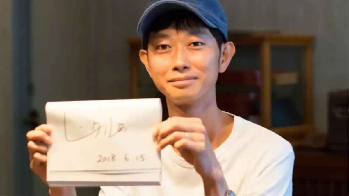Hombre japonés que se alquila a sí mismo y gana 80.000 euros al año, sosteniendo un cuaderno con una fecha escrita