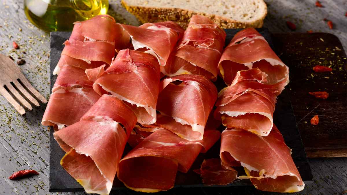 Lonchas de jamón serrano enrolladas en tabla, producto clave en la cocina tradicional de Lalín.