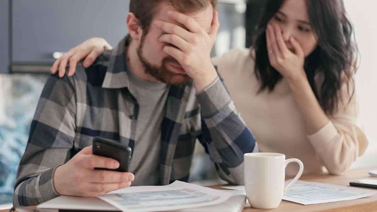 Pareja preocupada tras descubrir deudas bancarias de un familiar fallecido