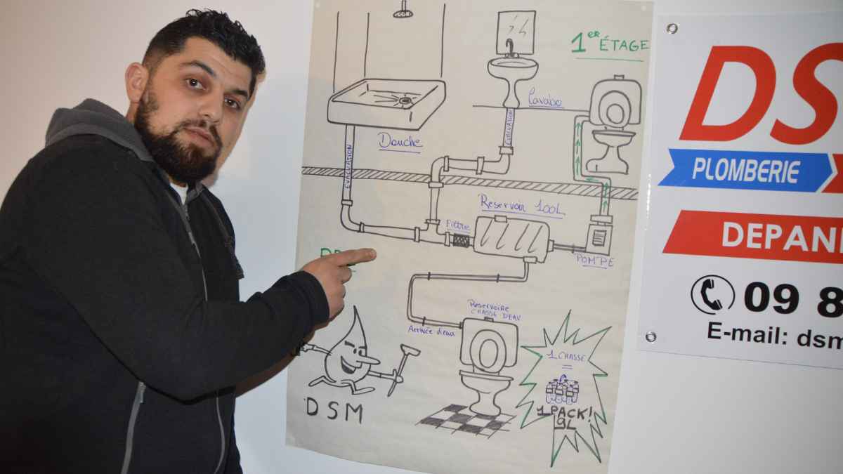 Fontanero francés mostrando esquema del invento para sustituir cisternas tradicionales del váter y ahorrar agua