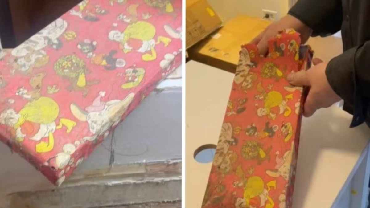 Regalo de Navidad antiguo con papel rojo decorado encontrado oculto en una pared durante reforma de baño