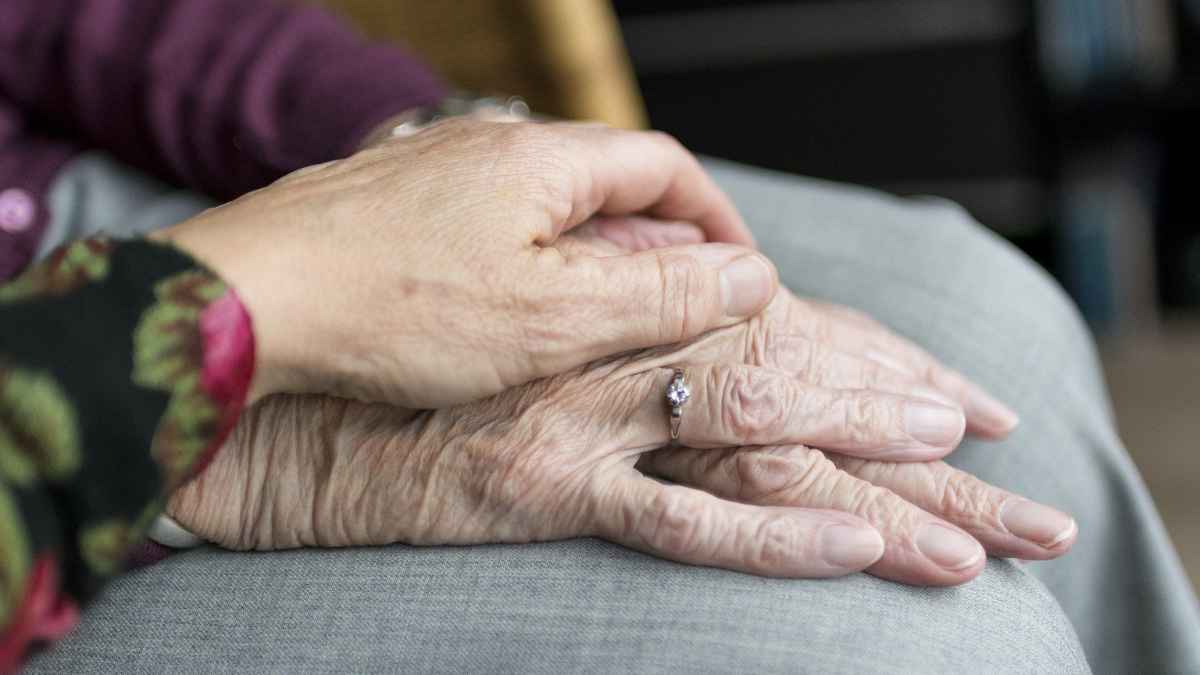 Manos de personas mayores que representan pensión de viudedad y cobro del paro