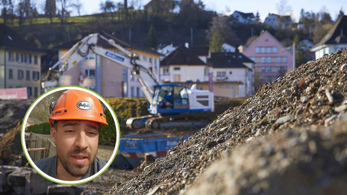 Trabajador de la construcción en Suiza con casco naranja en obra, mostrando las condiciones laborales del sector.