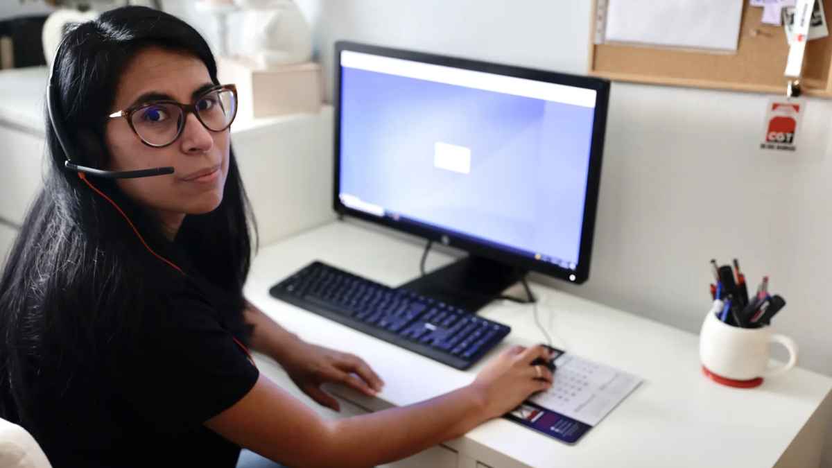 Teleoperadora trabajando con auriculares frente al ordenador