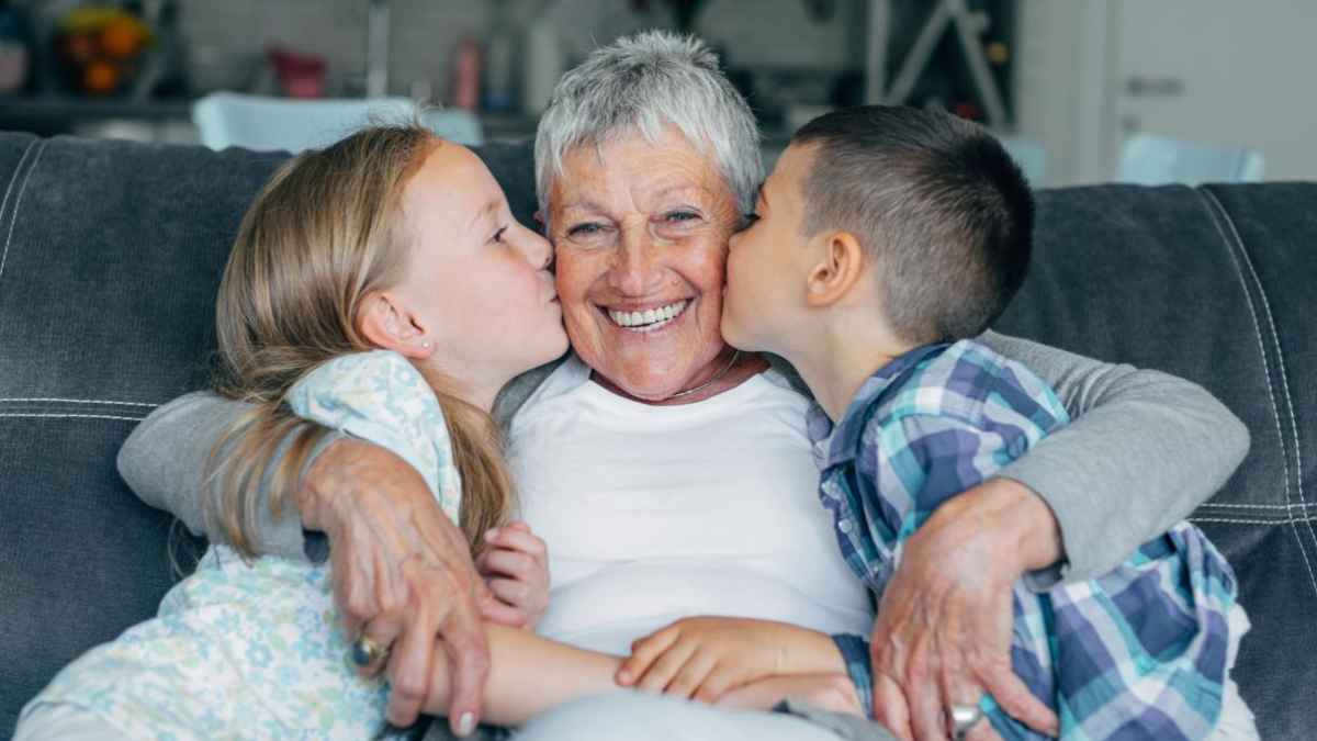 Abuela cuidando a sus dos nietos tras obtener la pensión no contributiva reconocida por la Justicia en Andalucía